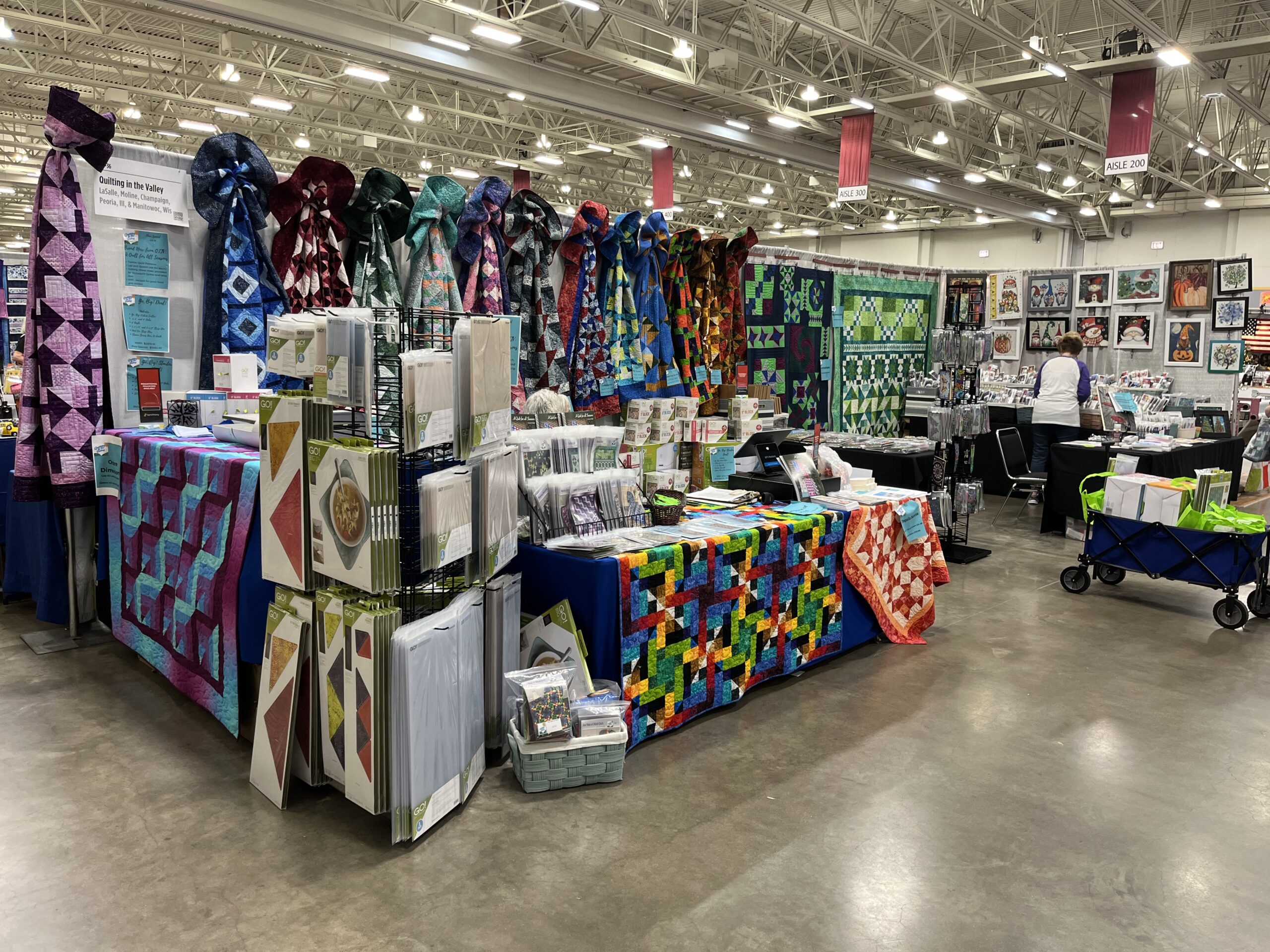 Booth layout with multicolored quilts and fabric