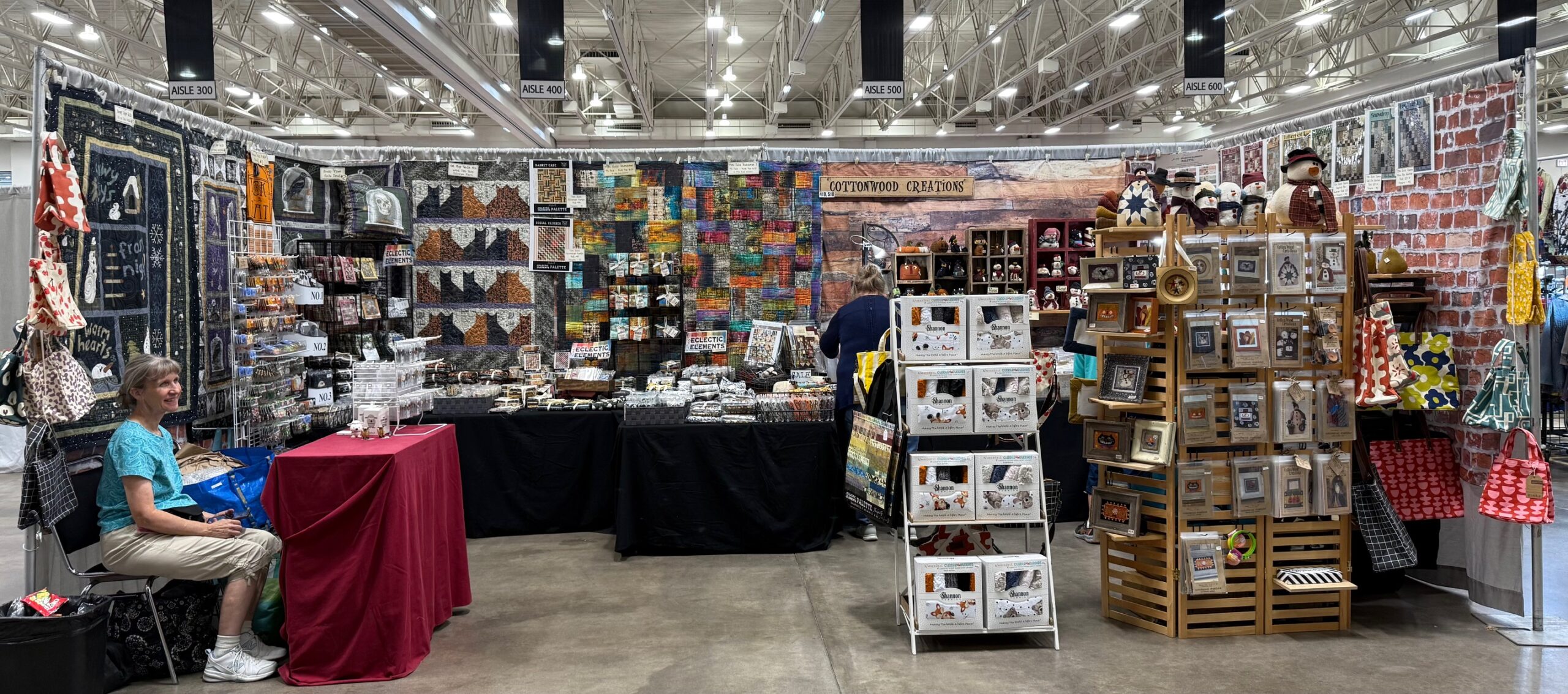 Cottonwood Creation's booth set up showing a wide variety patterns, kits, fabrics, and more