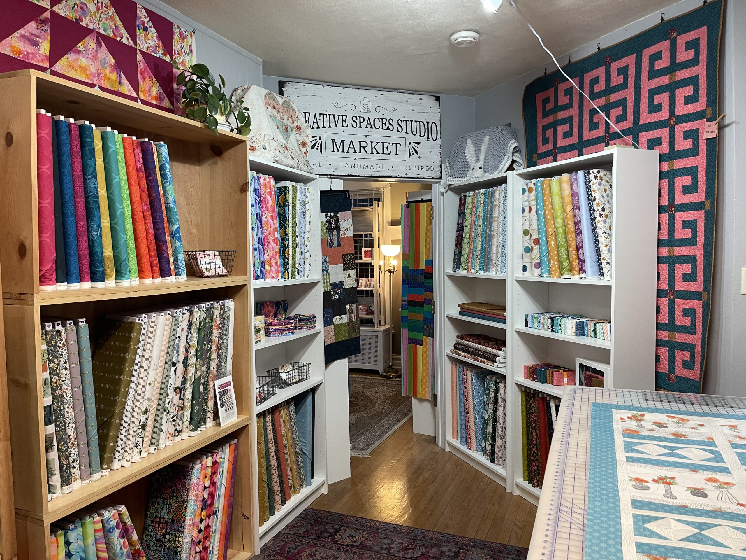 Various bolts of fabric on shelves
